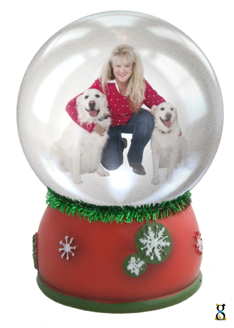 A woman with her two dogs inside a snow globe