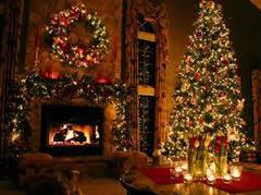 An elegant living room with a fireplace and large christmas tree and wreath