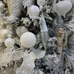 A close up of white christmas decorations on a tree