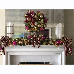 Red and gold christmas decorations above a fireplace