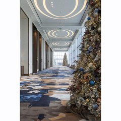 The interior hallway of a commercial building with a Christmas tree