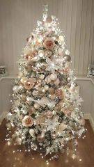 A christmas tree with white decorations