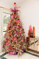 A christmas tree with pink and orange decorations