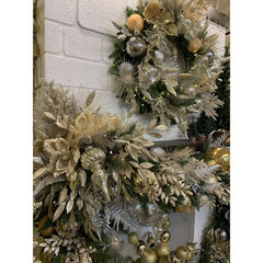 A Christmas wreath and garland with silver and gold decorations